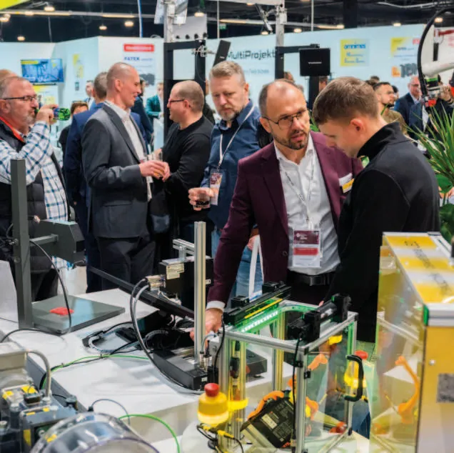 Business talks at an exhibitor stand, Warsaw Industry Week 2025
