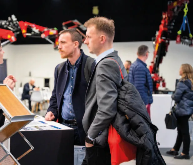 Visitors examining industrial equipment